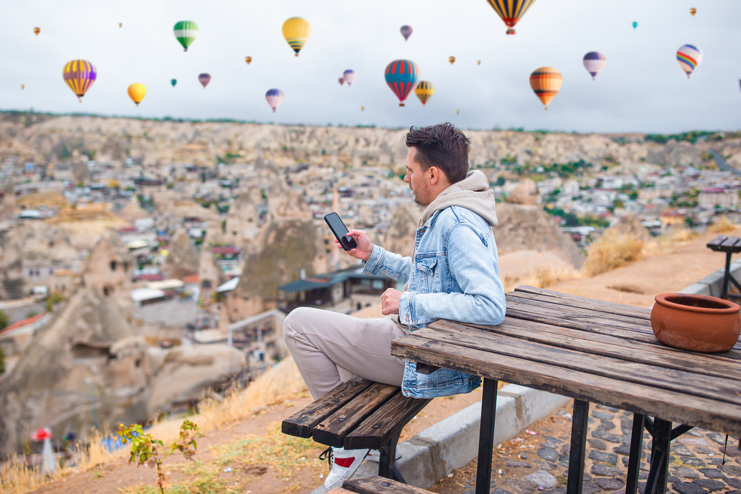 happy young- man watching hot air balloons in cappadocia turkey happy young- man watching hot air balloons in cappadocia turkey