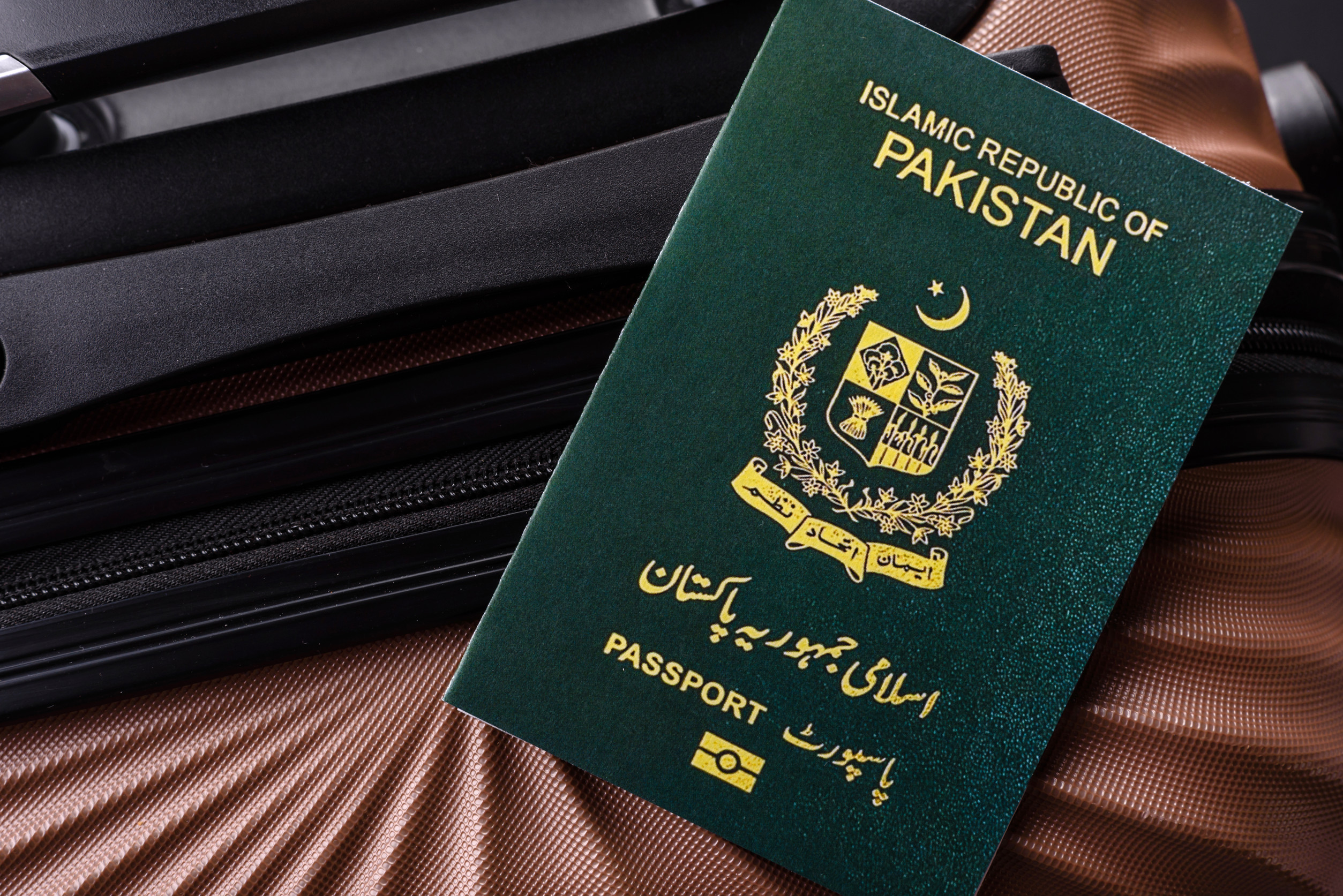 international passport of a citizen of pakistan on a suitcase departure from The Airport
