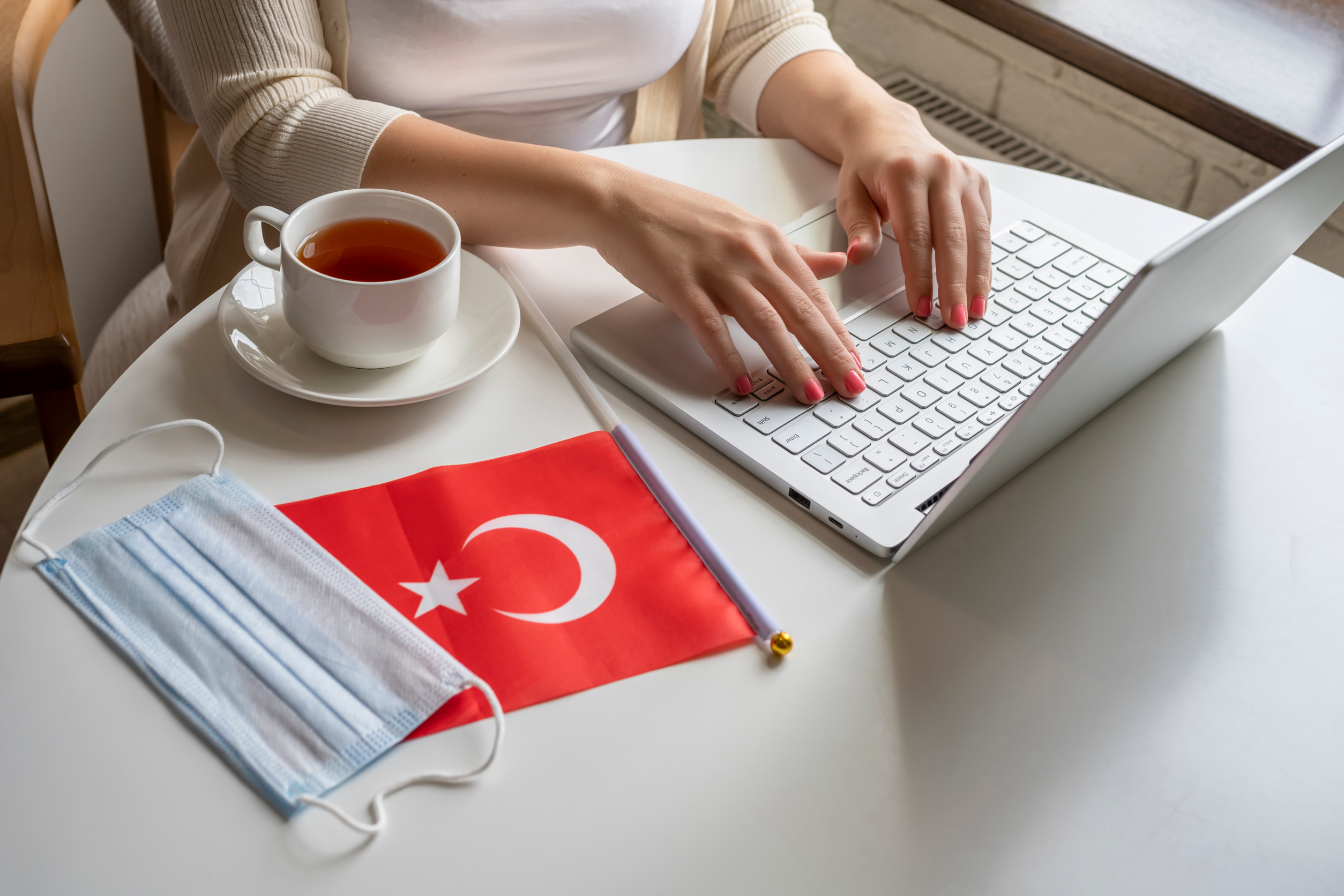 woman tourist having breakfast with cup of coffee working on laptop woman tourist having breakfast with cup of coffee working on laptop